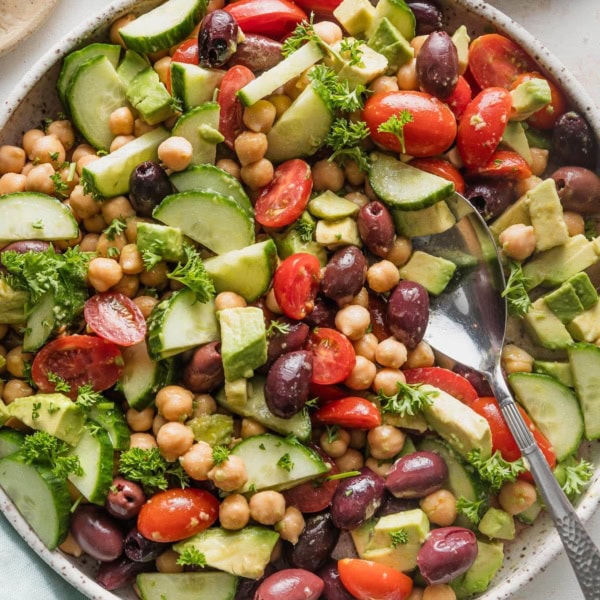 Overhead view of chickpea avocado salad in a large low bowl, ready to serve.