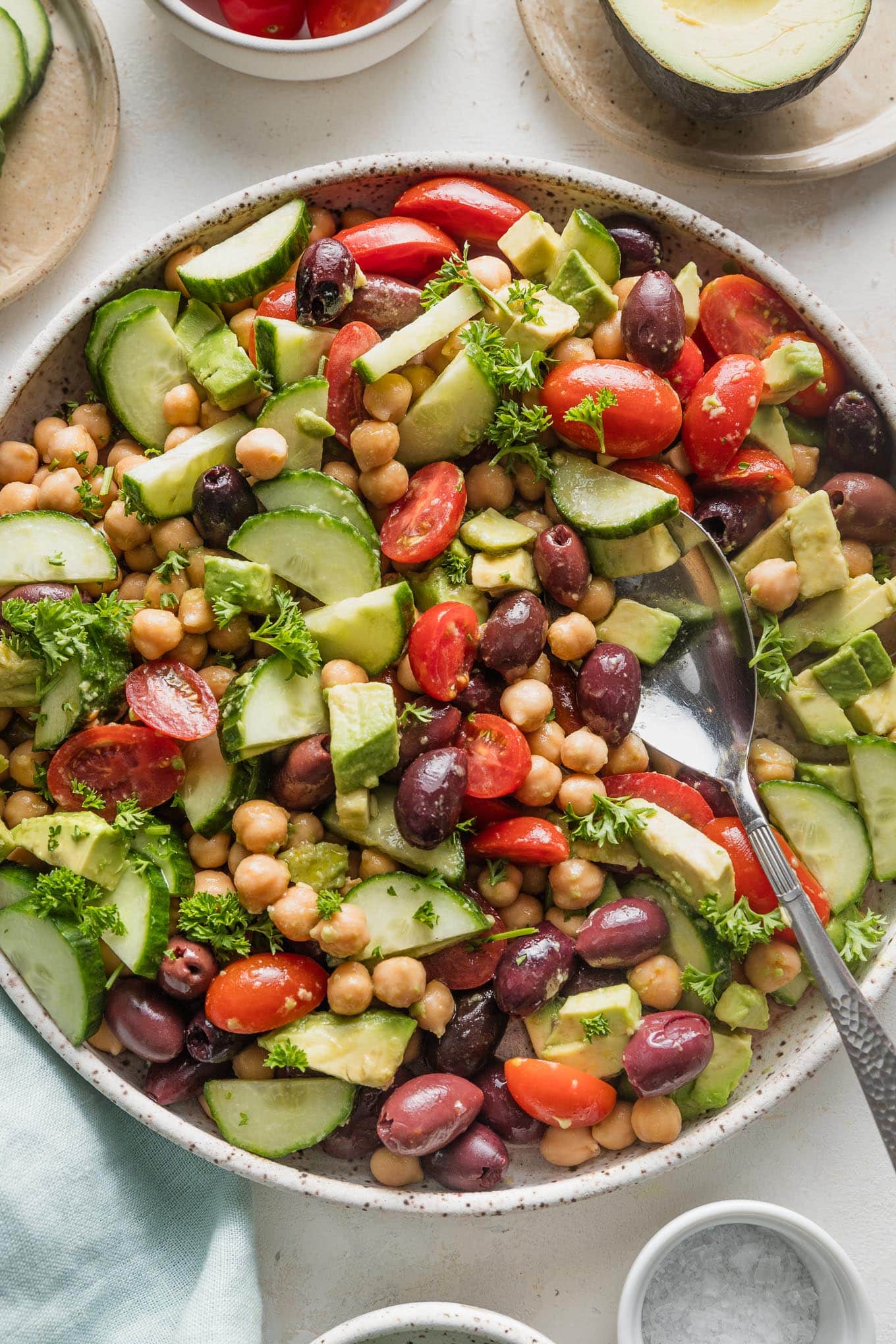 Overhead view of chickpea avocado salad in a large low bowl, ready to serve.
