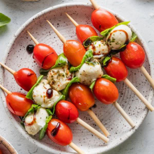 Small appetizer plate filled with Caprese skewers.