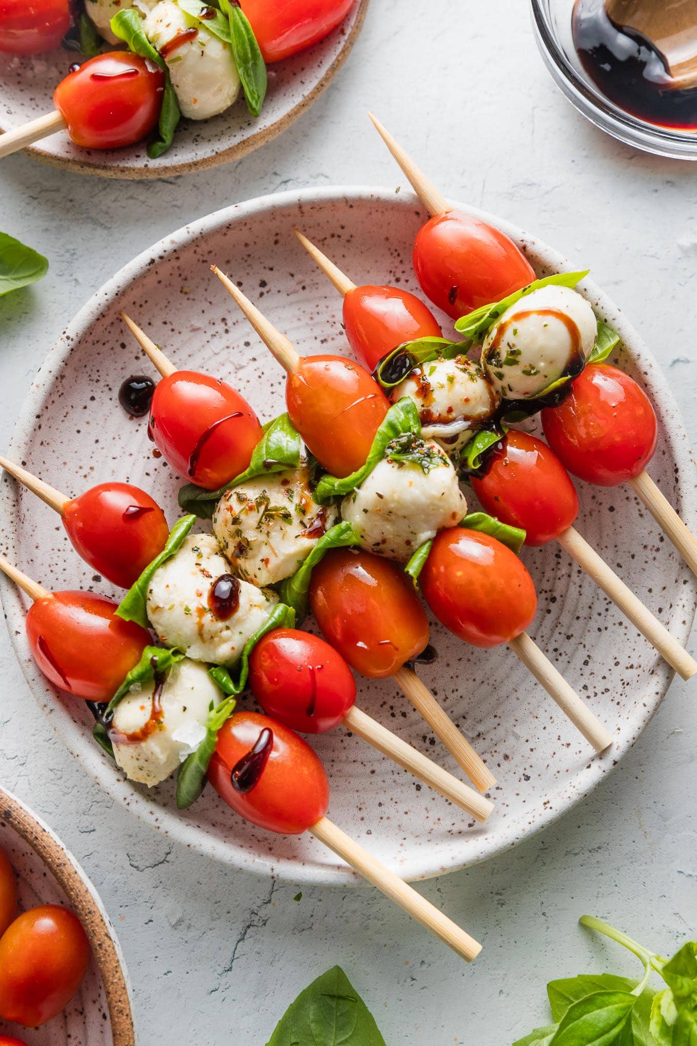Small appetizer plate filled with Caprese skewers.