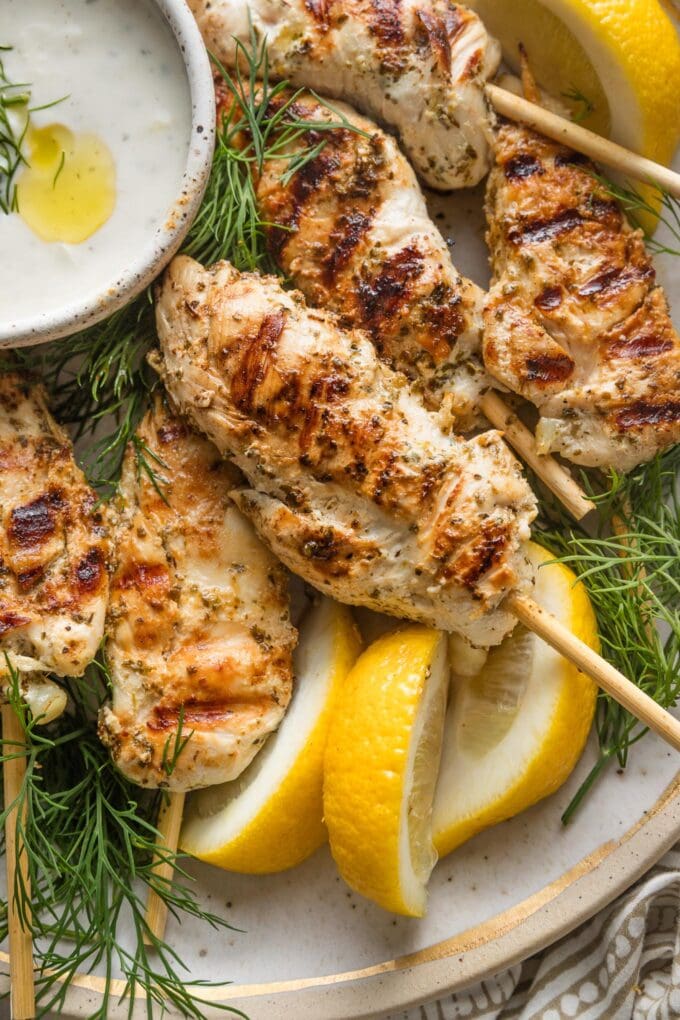 Close up of a grilled chicken skewer with deep, satisfying grill marks and a golden brown crust.