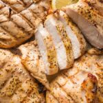 Sliced chicken breast seasoned with lemon pepper seasoning and cooked on the grill.