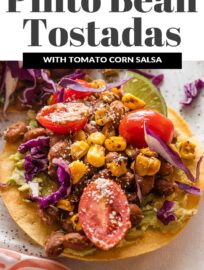 Pinto Bean Tostadas with the most delicious and vibrant street corn tomato salsa are one of my new favorite meatless meals and extra fun for entertaining! With creamy avocado, tender pinto beans, and a colorful salsa all layered on crisp, lightly salted homemade tostadas, these are an irresistible explosion of flavor and texture.