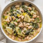 Low bowl filled with a Mediterranean-inspired beans and greens with Parmesan and Swiss chard.