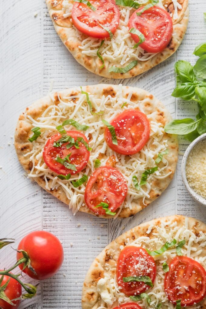 Assembled but uncooked caprese flatbreads.