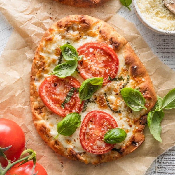 Caprese flatbread with fresh tomatoes and basil made on garlic naan.