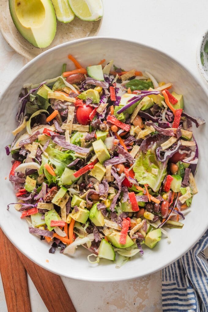 Overhead view of an easy everyday Mexican salad in a large bowl on a white countertop.