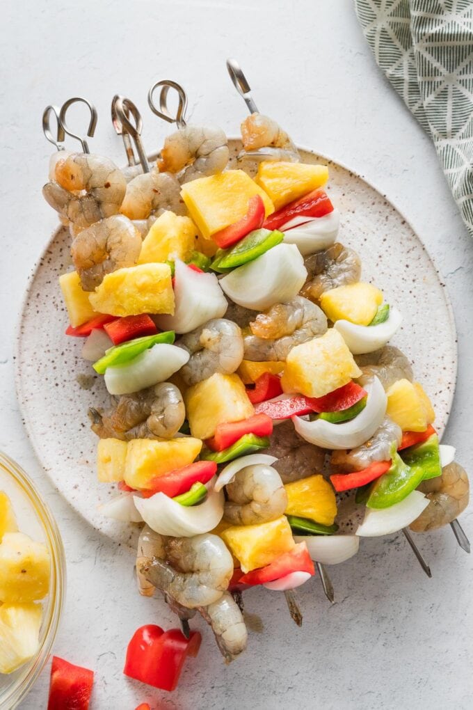 Uncooked shrimp pineapple kabobs with bell pepper and sweet onion.
