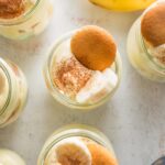 Overhead view of individual banana puddings topped with banana slices and Nilla wafers.
