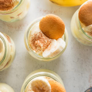 Overhead view of individual banana puddings topped with banana slices and Nilla wafers.