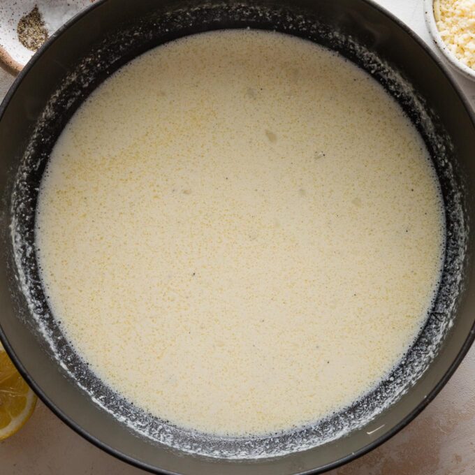 Light cream sauce in a large cast iron pan.