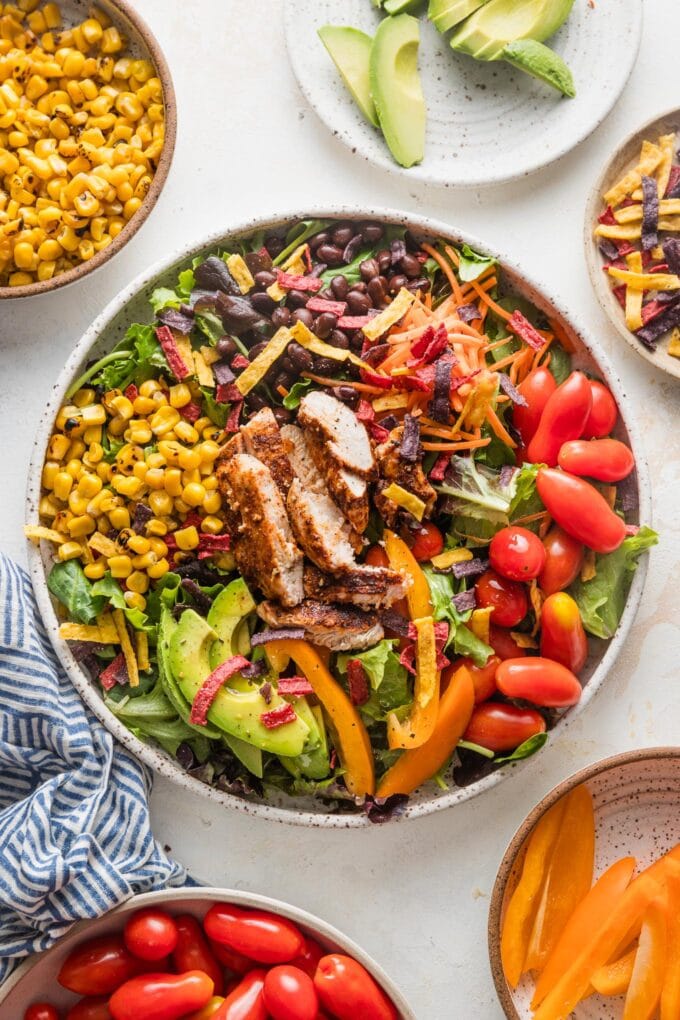 Overhead view of a large Santa Fe salad with chicken served in a large white ceramic bowl.