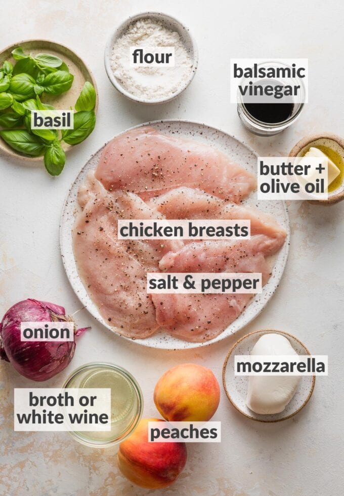 Labeled overhead photo of thin-sliced chicken breasts seasoned with salt and pepper, fresh basil, mozzarella cheese, fresh peaches, balsamic vinegar, flour, a red onion, butter and olive oil, all in prep bowls and ready to cook.