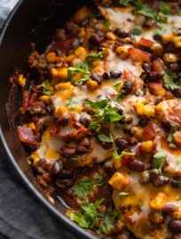 Close of a chicken breast seasoned with Southwest spices and cooked with salsa, black beans, and corn.