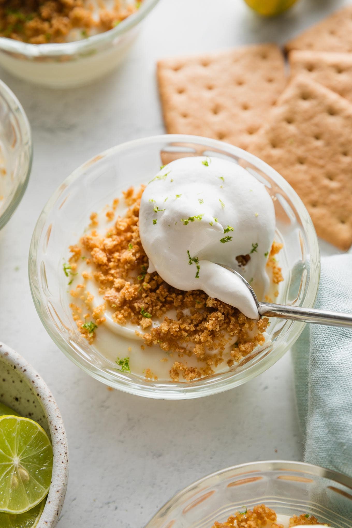 Small custard dish with an individual portion of no bake key lime pie served "upside down," with graham cracker crumbs on top.