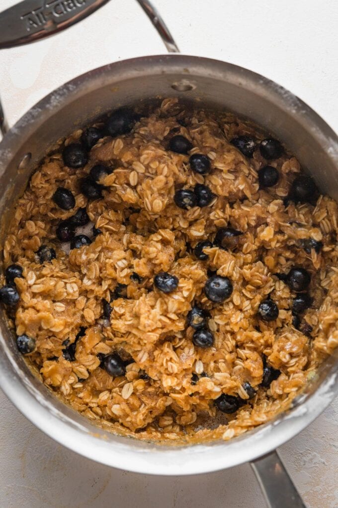 Blueberry oatmeal cookie dough mixed together in a pan.