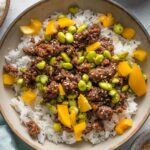 Ground beef bowl with edamame, bell pepper, and sesame seeds served over jasmine rice.
