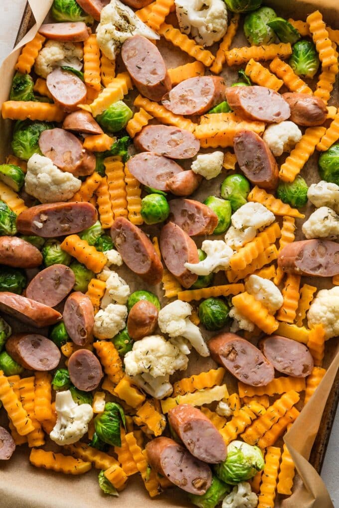 Sausage sliced and added to a sheet pan with harvest veggies.