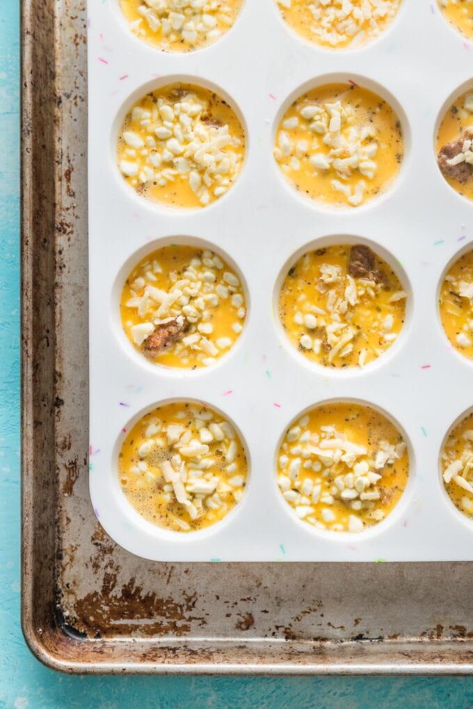 An egg and cottage cheese mixture poured over sausage in silicone muffin tins.