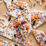 Close up of "boo bark" - a thin layer of white chocolate with Halloween-themed sprinkles stuck on top.