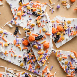Close up of "boo bark" - a thin layer of white chocolate with Halloween-themed sprinkles stuck on top.