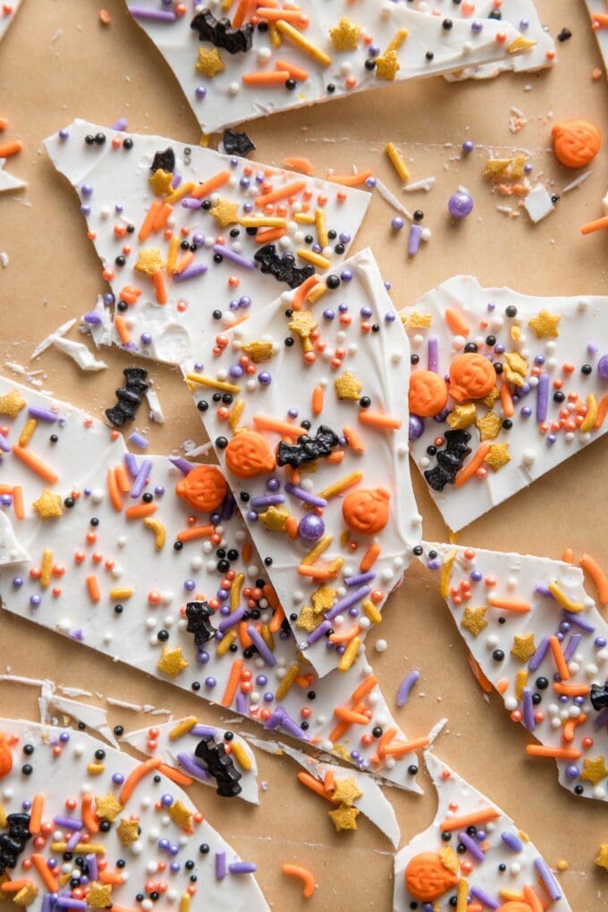Close up of "boo bark" - a thin layer of white chocolate with Halloween-themed sprinkles stuck on top.