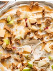 Creamy and rich, this Caramel Apple Cheesecake Dip is a dreamy appetizer or shareable dessert for any fall gathering, with real whipped cream, caramel sauce, and sea salt. Serve with apple slices, graham crackers, and Biscoff cookies for dipping.