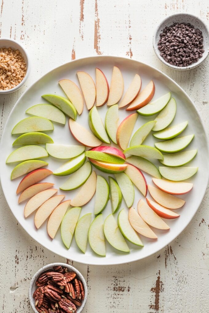 Large platter with thinly-sliced apples arranged in a circular pattern.