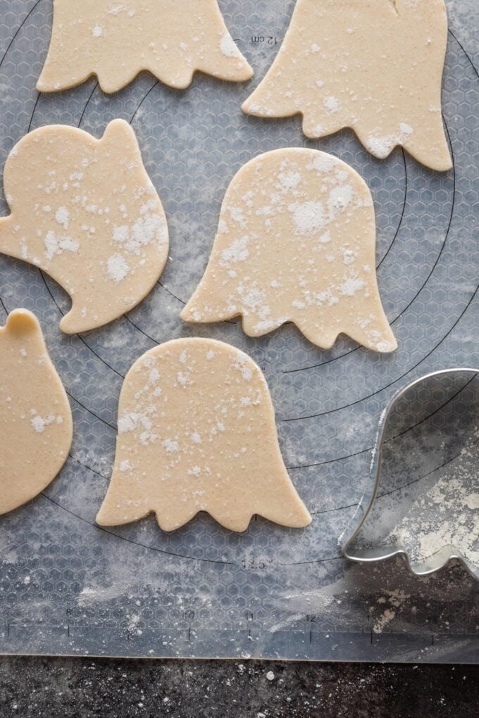 Cut pie crust ghost shapes on a lightly-floured pastry mat.