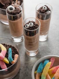 Cute, quick, and tasty, Halloween Dirt Cup Shooters are a fun spin on a classic easy dessert. Whip up the creamy chocolate pudding then have fun with the toppings; they can be as simple or as involved as you want them to be.