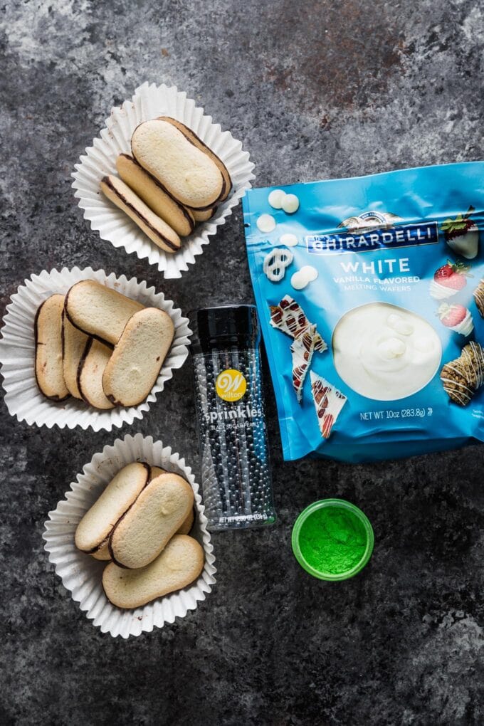 Milano cookies, Ghirardelli white vanilla flavored melts, black pearl candy sprinkles, and green edible dust.