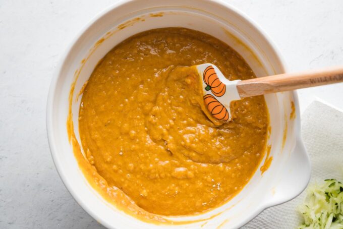 Pumpkin zucchini muffin batter mixed together.
