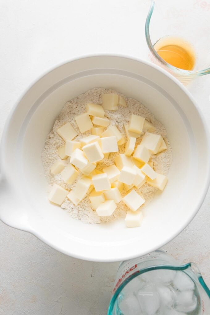 Half-inch pieces of butter added to a flour-sugar-salt mixture.