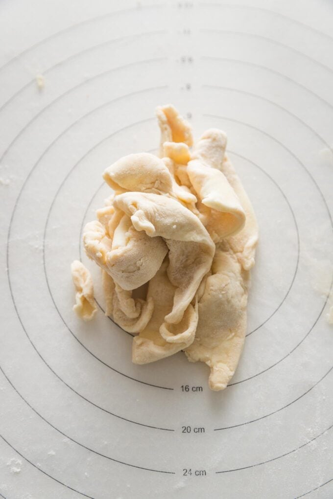 Pie crust scraps gathered on a pastry mat and ready to re-roll.