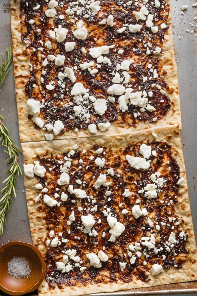 Flatbreads topped with fig preserves and feta, ready to bake.