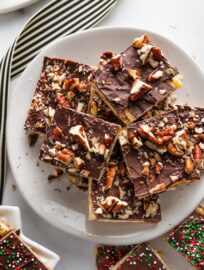 A classic treat that satisfies every sweet-salty craving, Christmas Cracker Candy has crisp Saltines, soft caramel, melted chocolate, and all the toppings your heart may desire. Besides the absolutely irresistible taste, my favorite thing about this treat is how easy it is to make in a big batch — perfect for sharing!