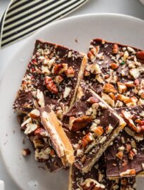 A classic treat that satisfies every sweet-salty craving, Christmas Cracker Candy has crisp Saltines, soft caramel, melted chocolate, and all the toppings your heart may desire. Besides the absolutely irresistible taste, my favorite thing about this treat is how easy it is to make in a big batch — perfect for sharing!