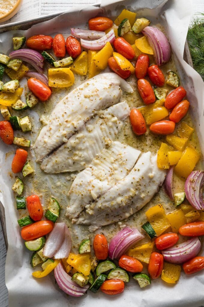 Sheet pan with Greek tilapia and veggies, just out of the oven.