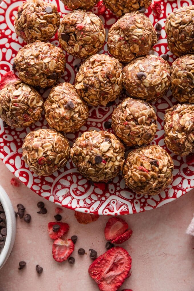 Close up of protein bites with mini chocolate chips, chocolate protein powder, and freeze-dried strawberries.