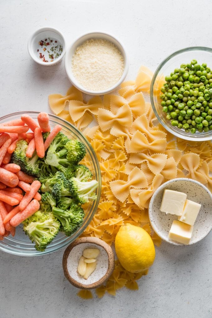 Overhead view of ingredients for a broccoli carrot pasta with a light lemon garlic sauce.