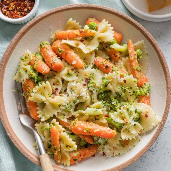 Bowl of broccoli carrot pasta with lemon and Parmesan.