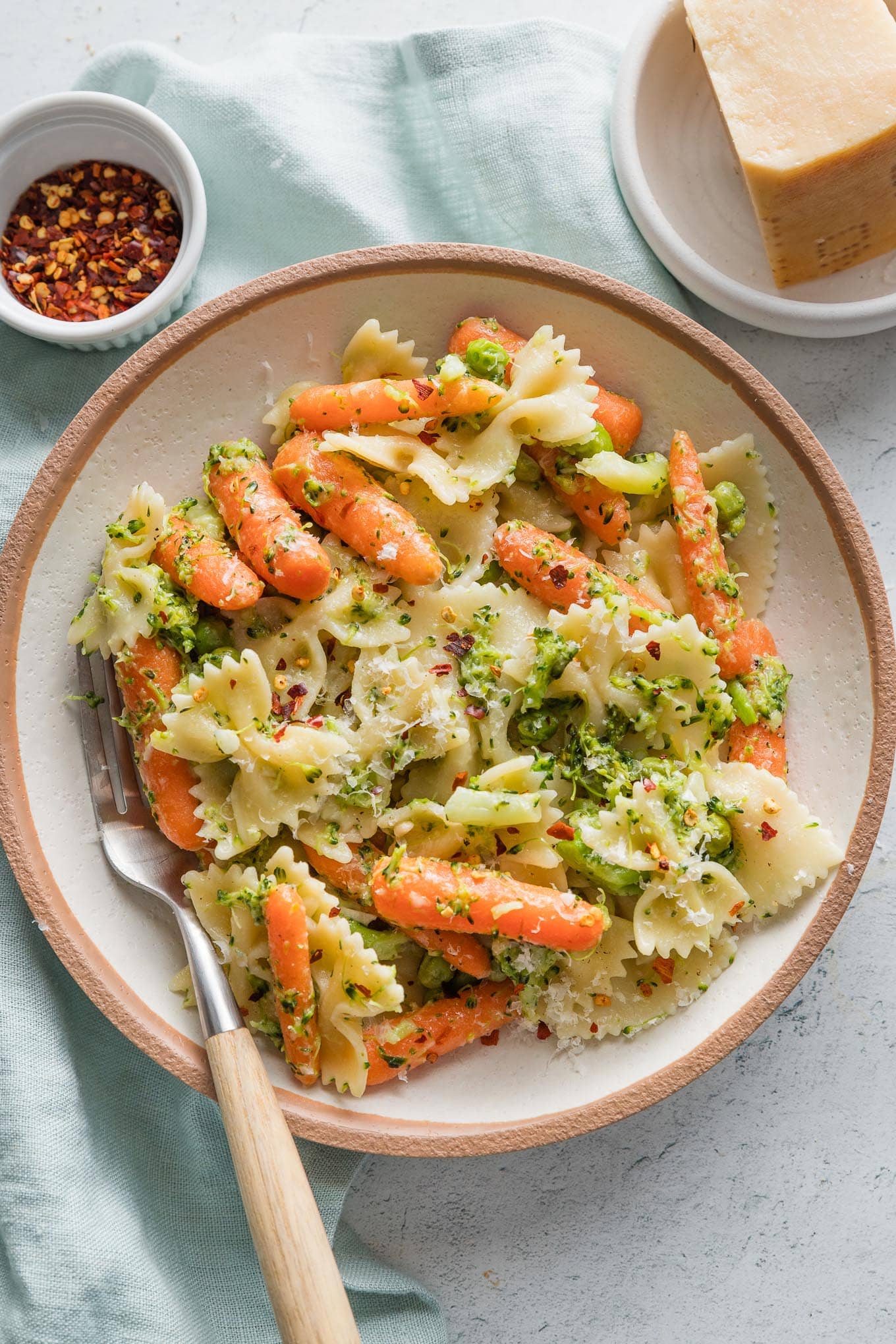 Bowl of broccoli carrot pasta with lemon and Parmesan.