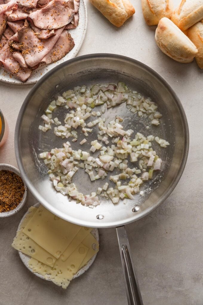 Skillet with lightly cooked shallot in butter.