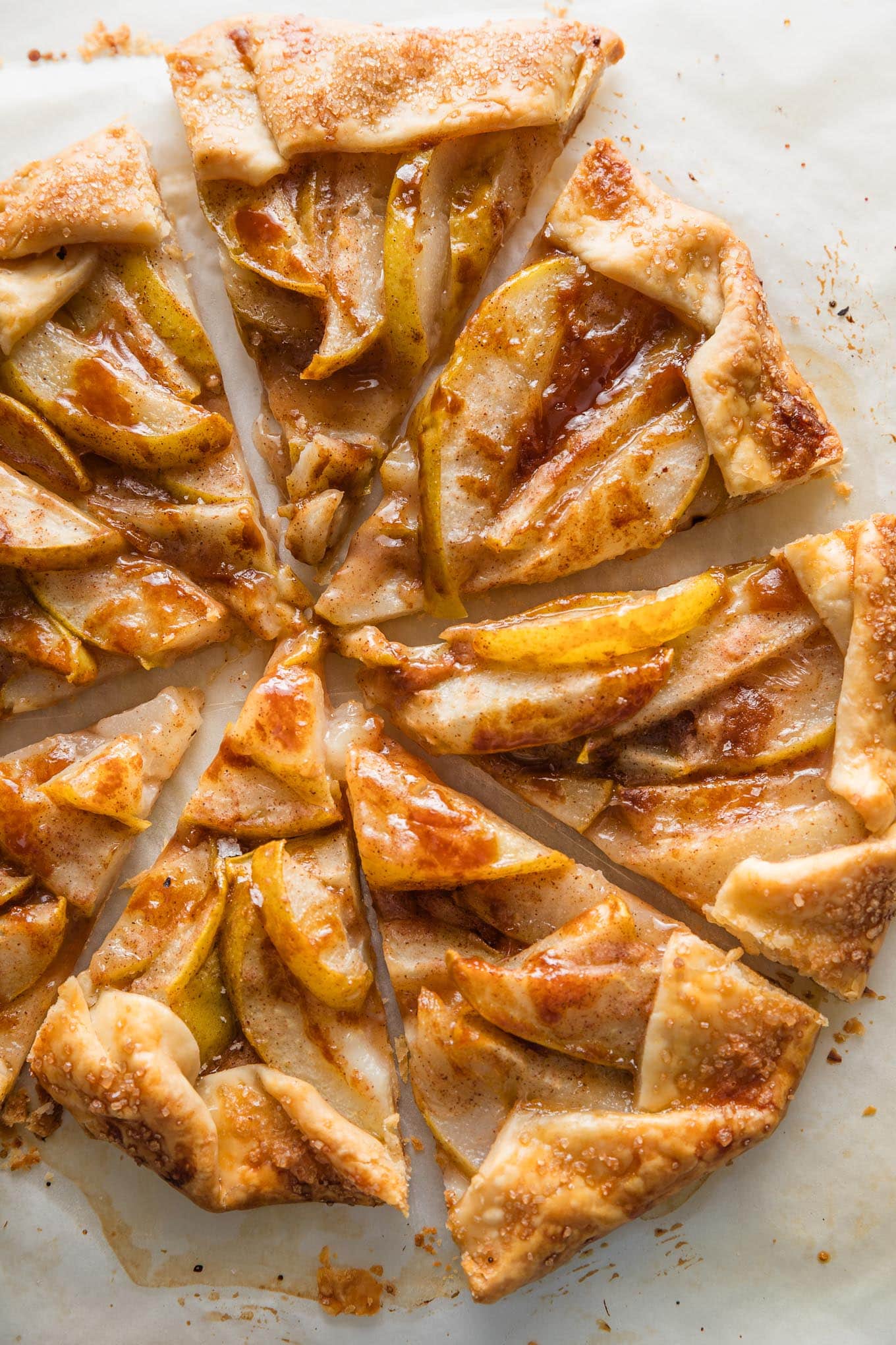 A pear caramel galette just baked and cut into eight wedges, ready to serve.