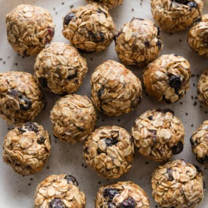 Close up of blueberry chia protein bites on a plate.