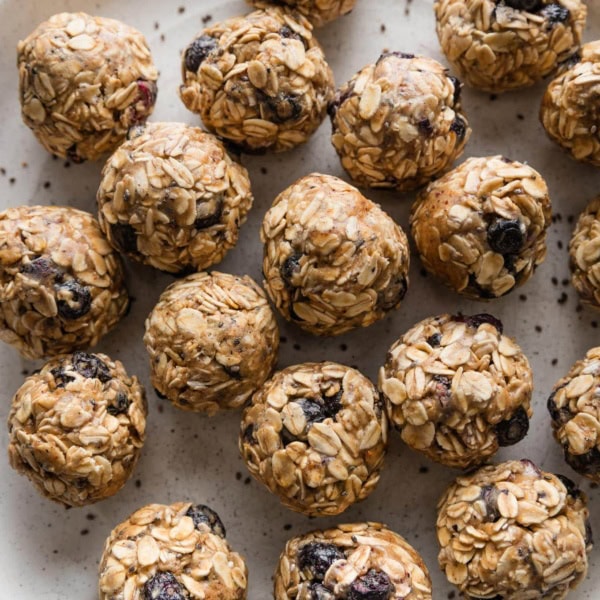 Close up of blueberry chia protein bites on a plate.