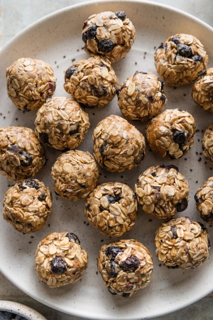 Close up of blueberry chia protein bites on a plate.