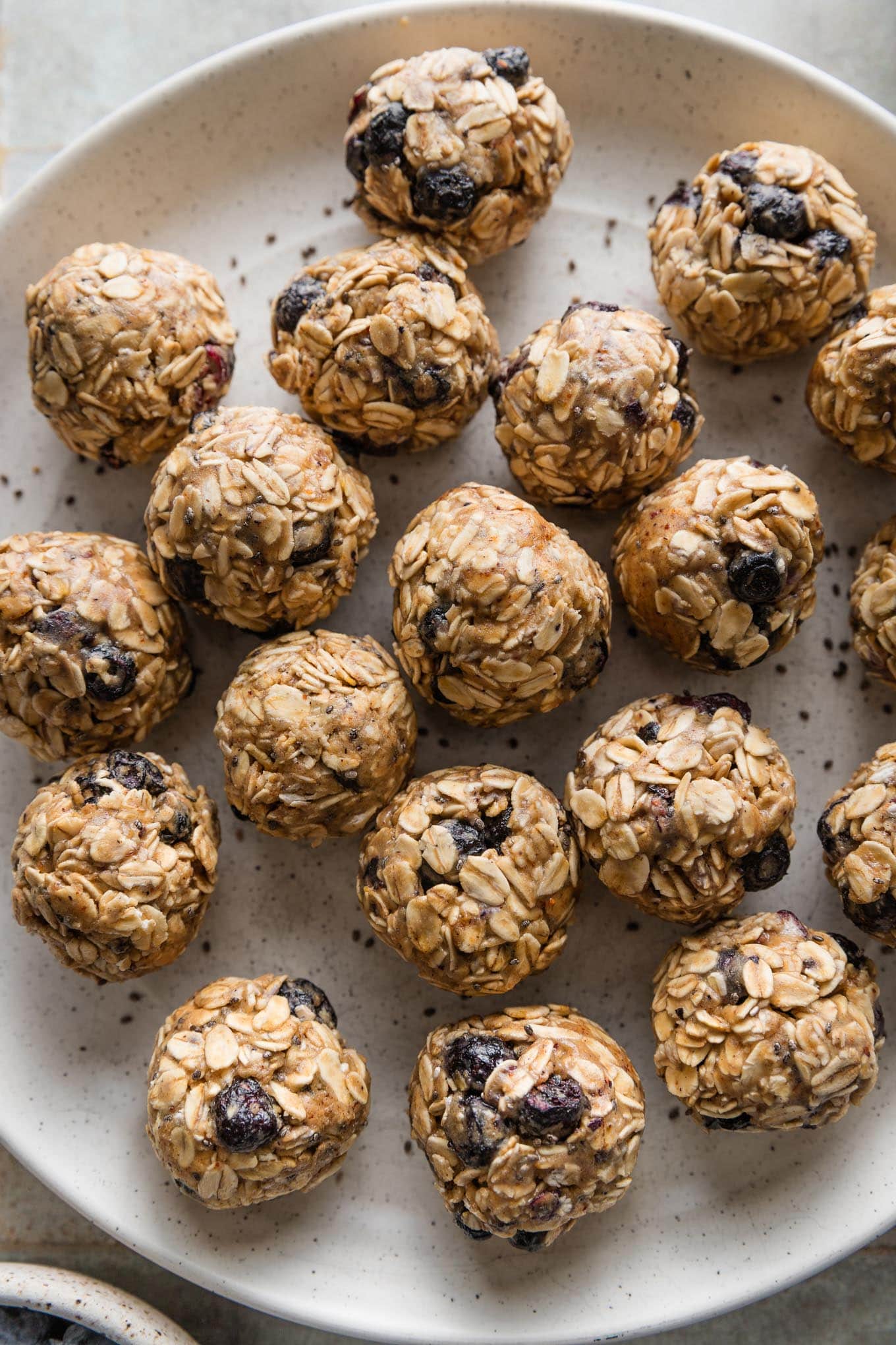 Close up of blueberry chia protein bites on a plate.