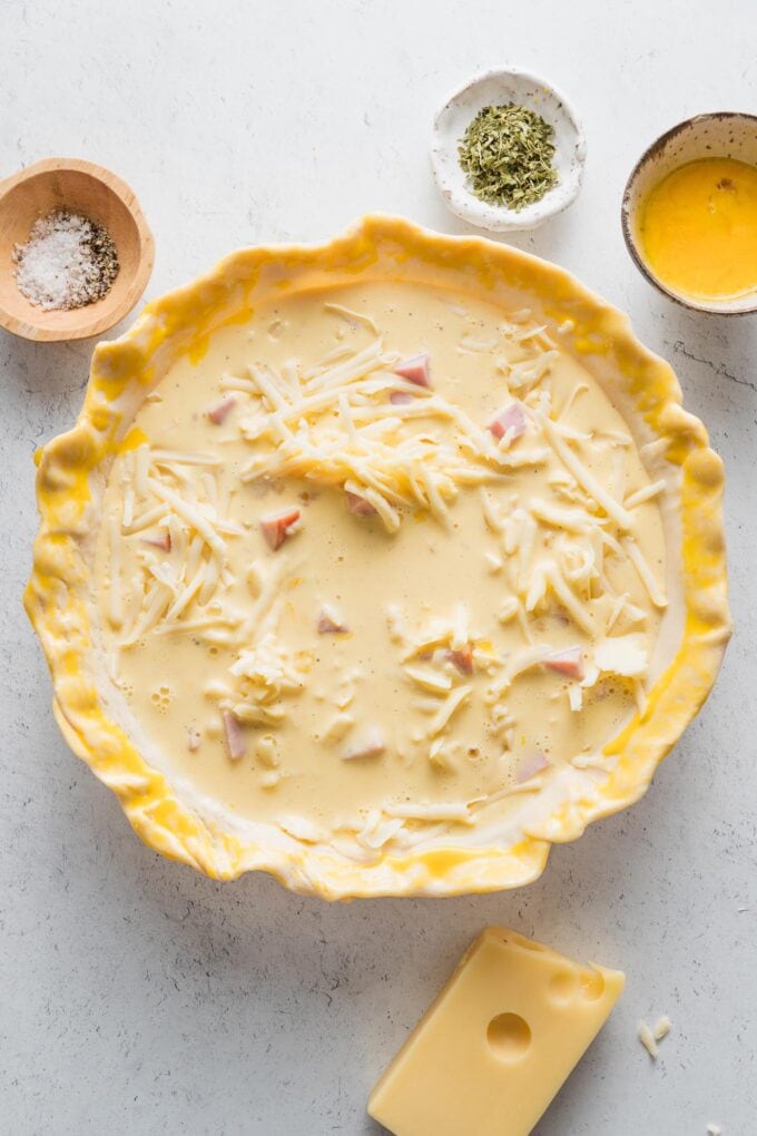 Egg-cream mixture poured over ham in a pie crust to form an uncooked quiche.