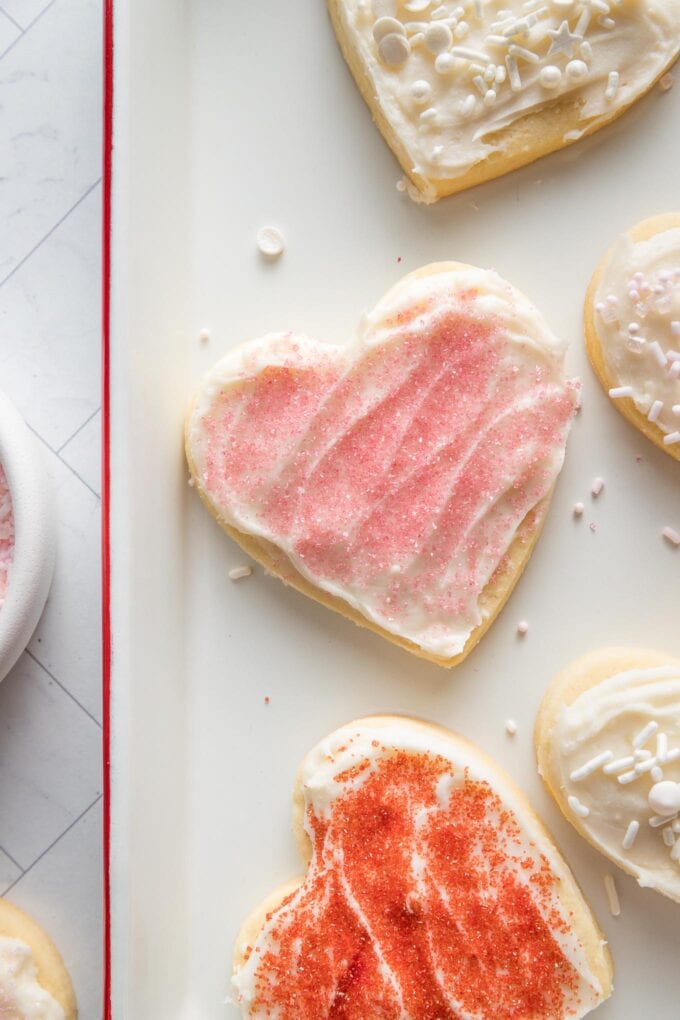 Close up of spreadable cream cheese frosting spread on a sugar cookie to show a light crust on top.